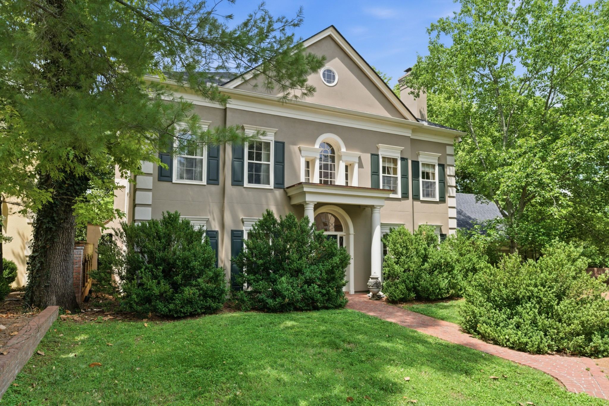 Front exterior of 102 Bellebrook Circle, a two story traditional home with shutters, a front lawn and trees, one of the Belle Meade homes for sale in Nashville