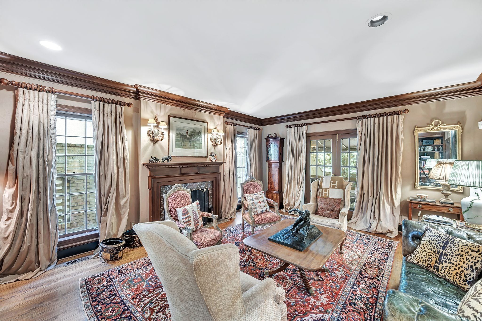 Den with a fireplace, built in bookshelves and patterned rugs at 102 Bellebrook Circle in Belle Meade Nashville