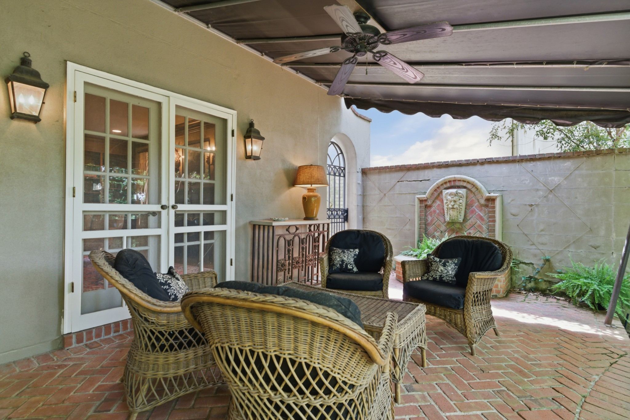 Covered terrace with wicker seating and a retractable awning at 102 Bellebrook Circle in Belle Meade Nashville