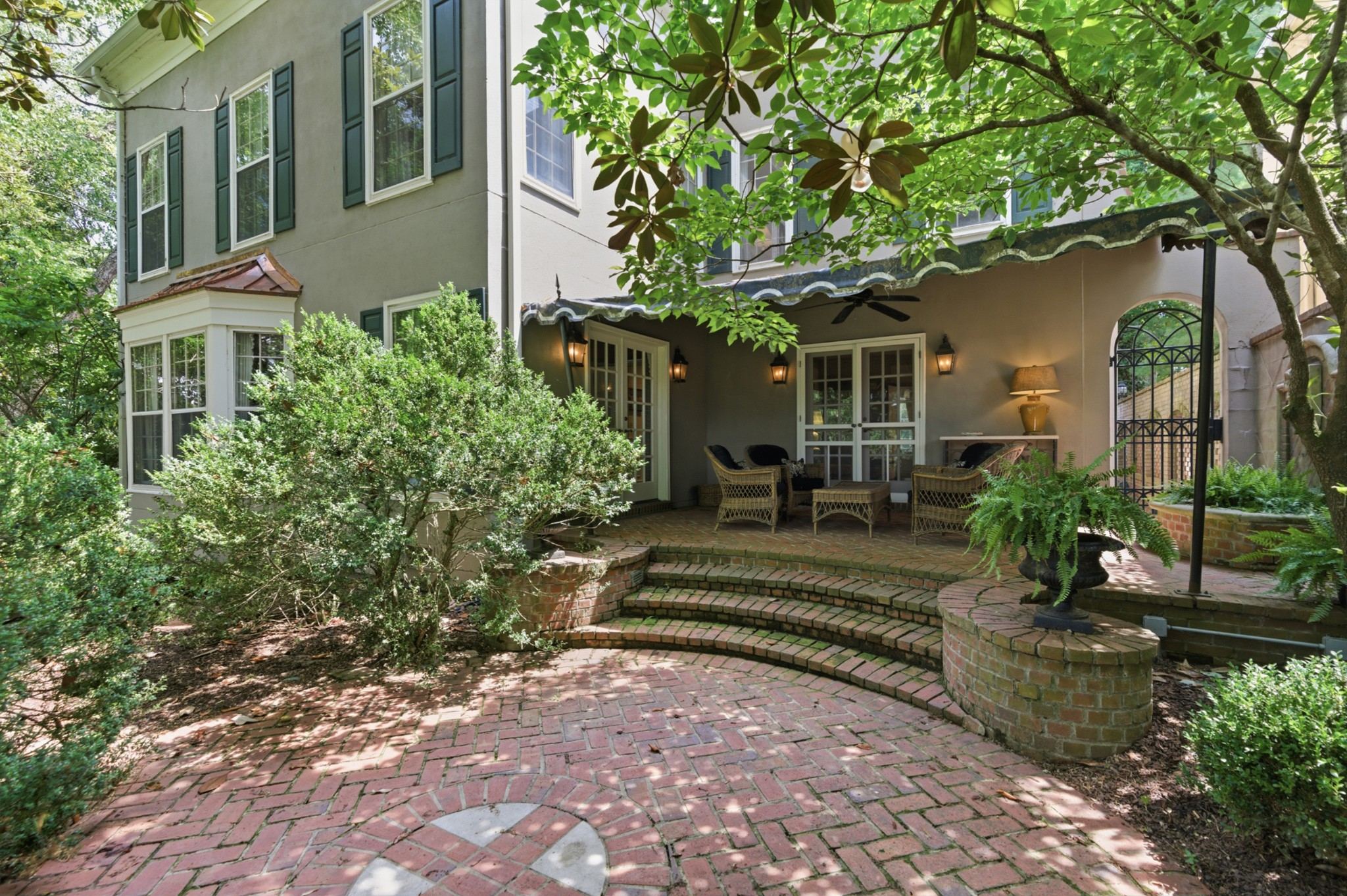 Rear exterior of 102 Bellebrook Circle with brick steps and mature landscaping in Belle Meade Nashville