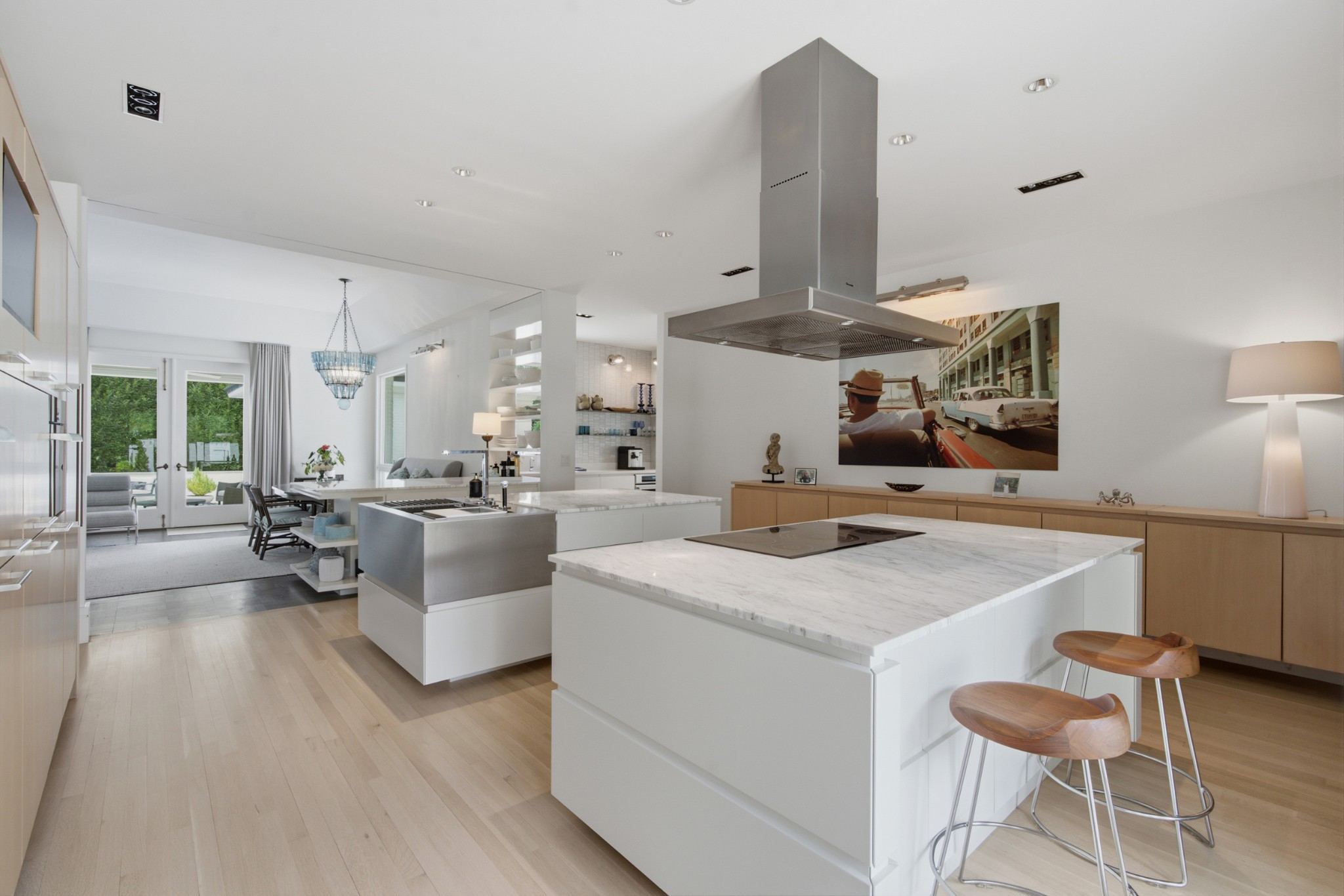White kitchen with an island and a stainless range hood at 109 Westhampton Place in Belle Meade Nashville