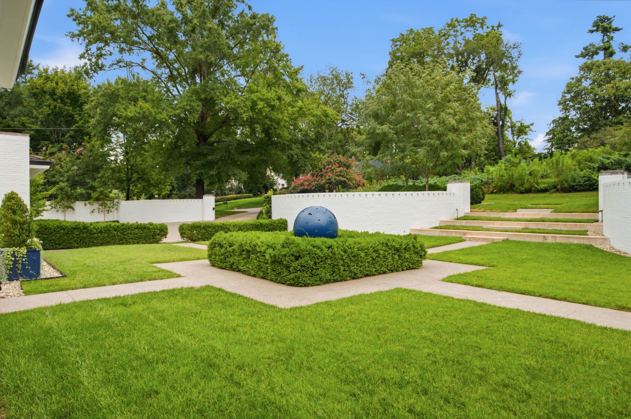 Formal garden with clipped hedges and lawn at 109 Westhampton Place in Belle Meade Nashville