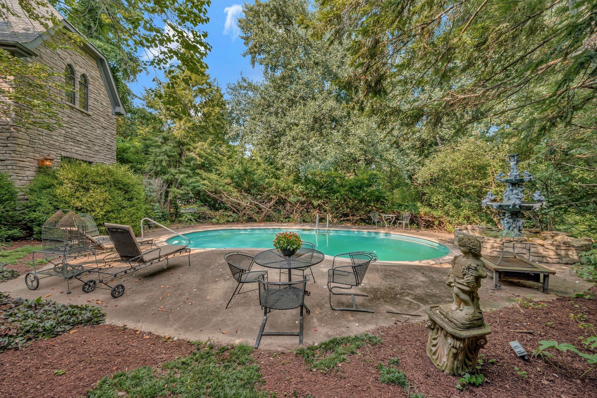 Kidney shaped gunite pool with landscaping behind 1108 Belle Meade Boulevard in Belle Meade Nashville