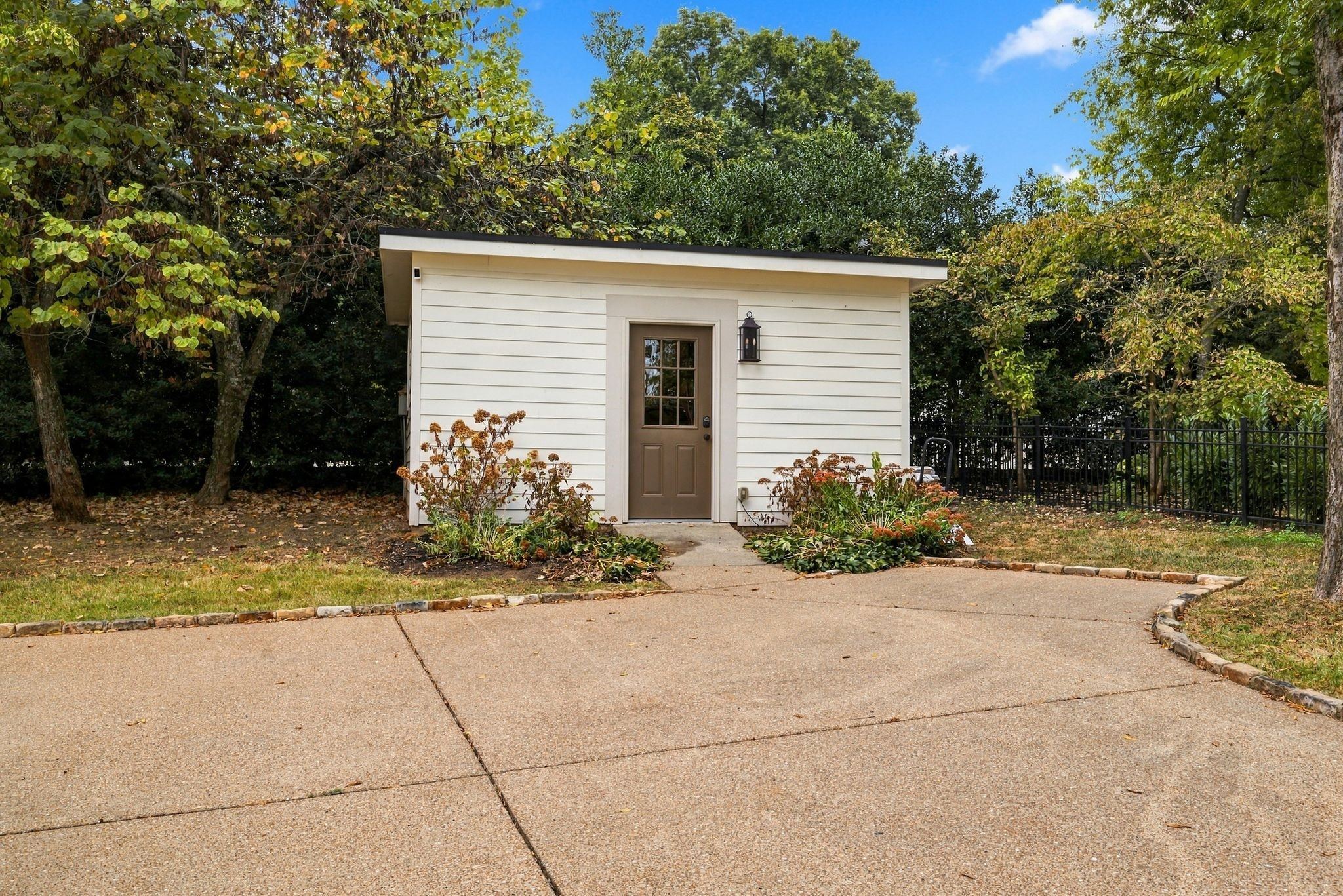 Separate finished outbuilding with a small porch at the end of the driveway at 200 Leake Avenue in Belle Meade Nashville