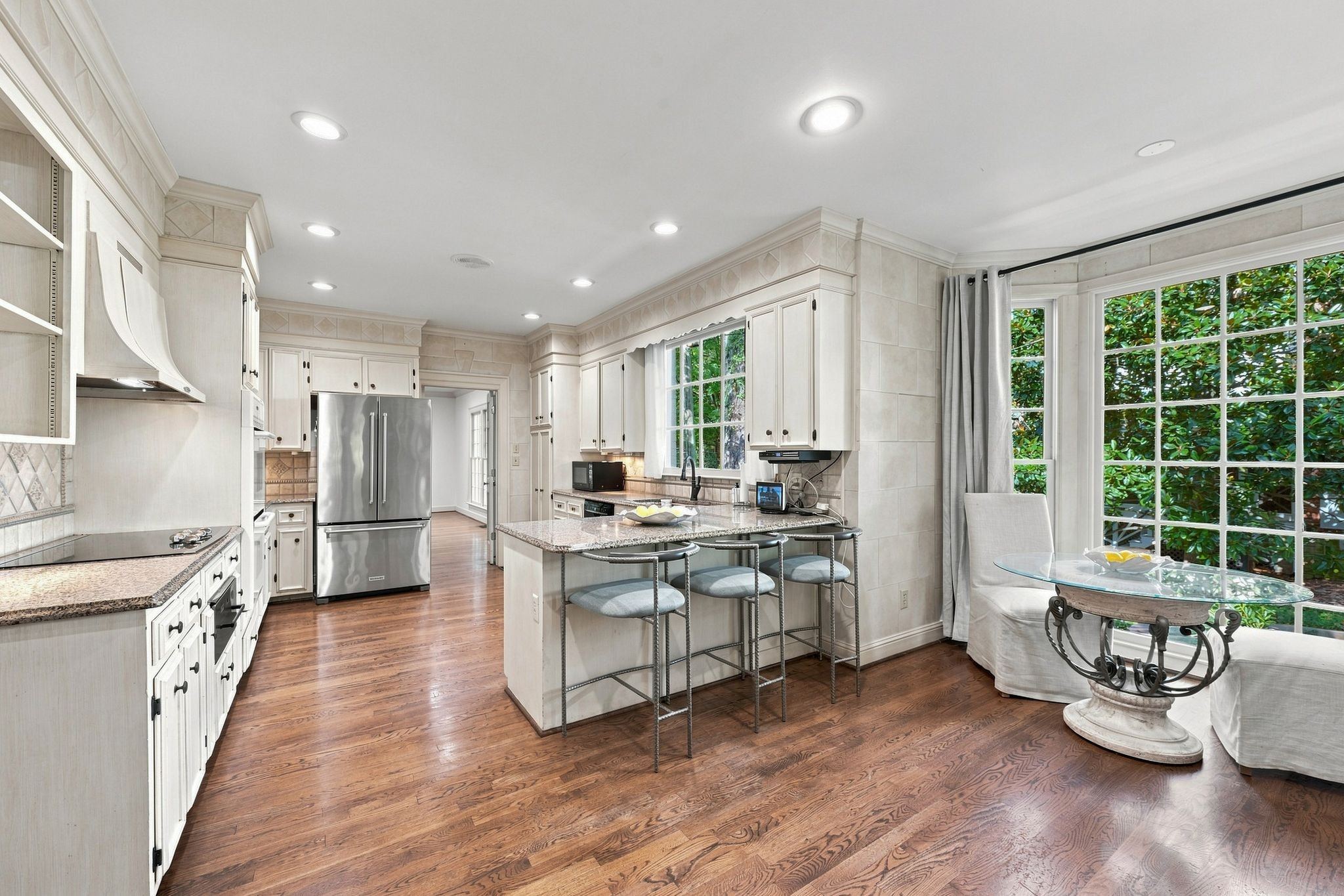 Kitchen open to a den with a breakfast bar and large windows at 317 Sutherland Avenue in Belle Meade Nashville