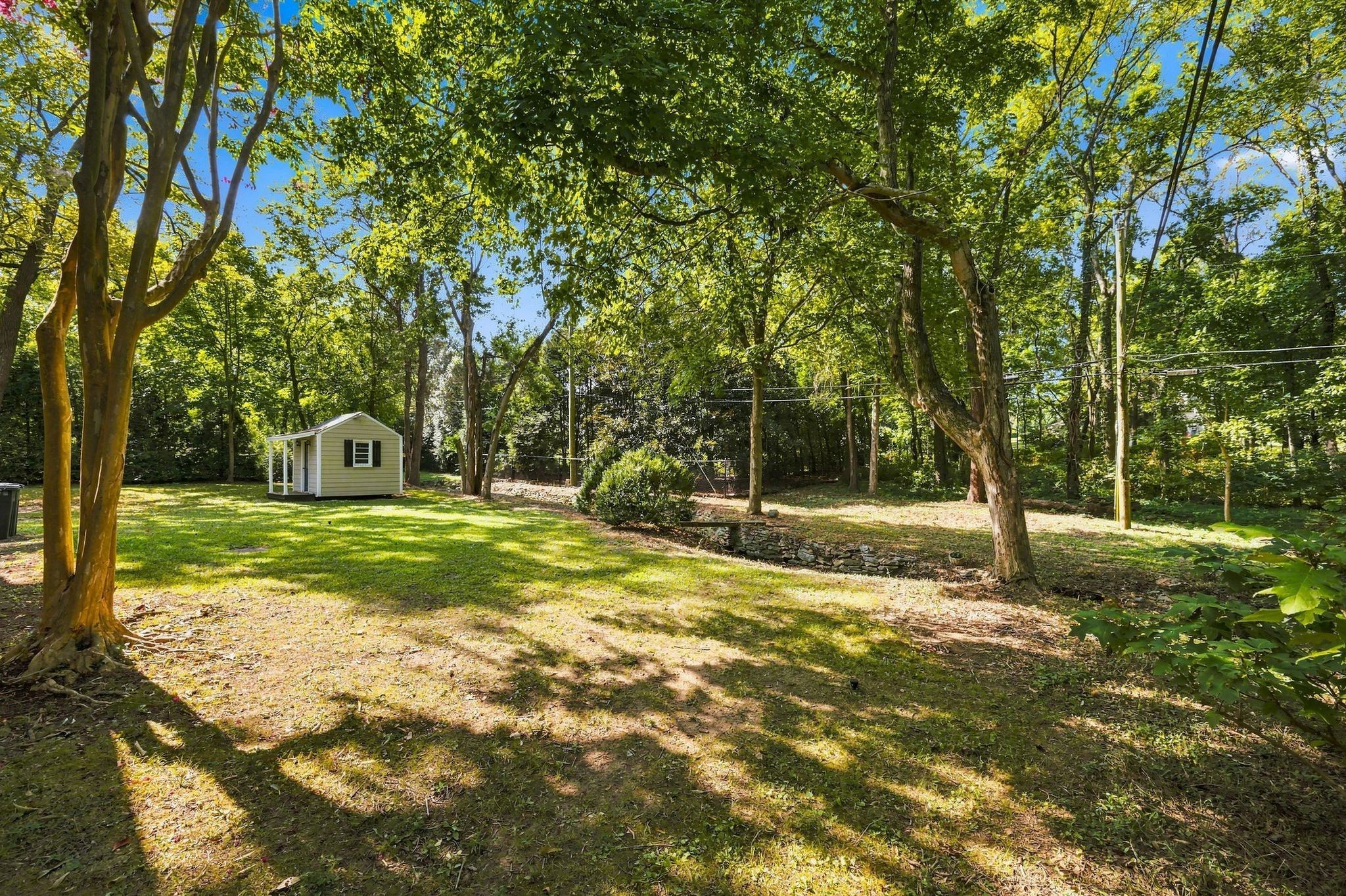 Private back yard with mature trees behind 317 Sutherland Avenue in Belle Meade Nashville