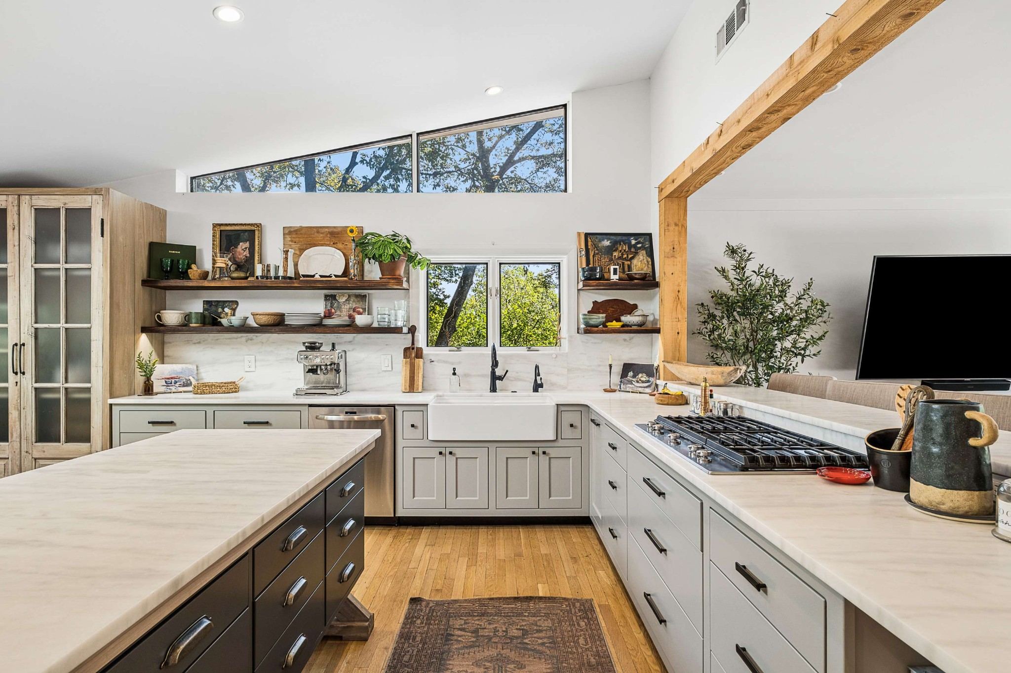 Kitchen with a large island, open shelving, skylights and light wood floors at 4301 Lillywood Road in Belle Meade Nashville