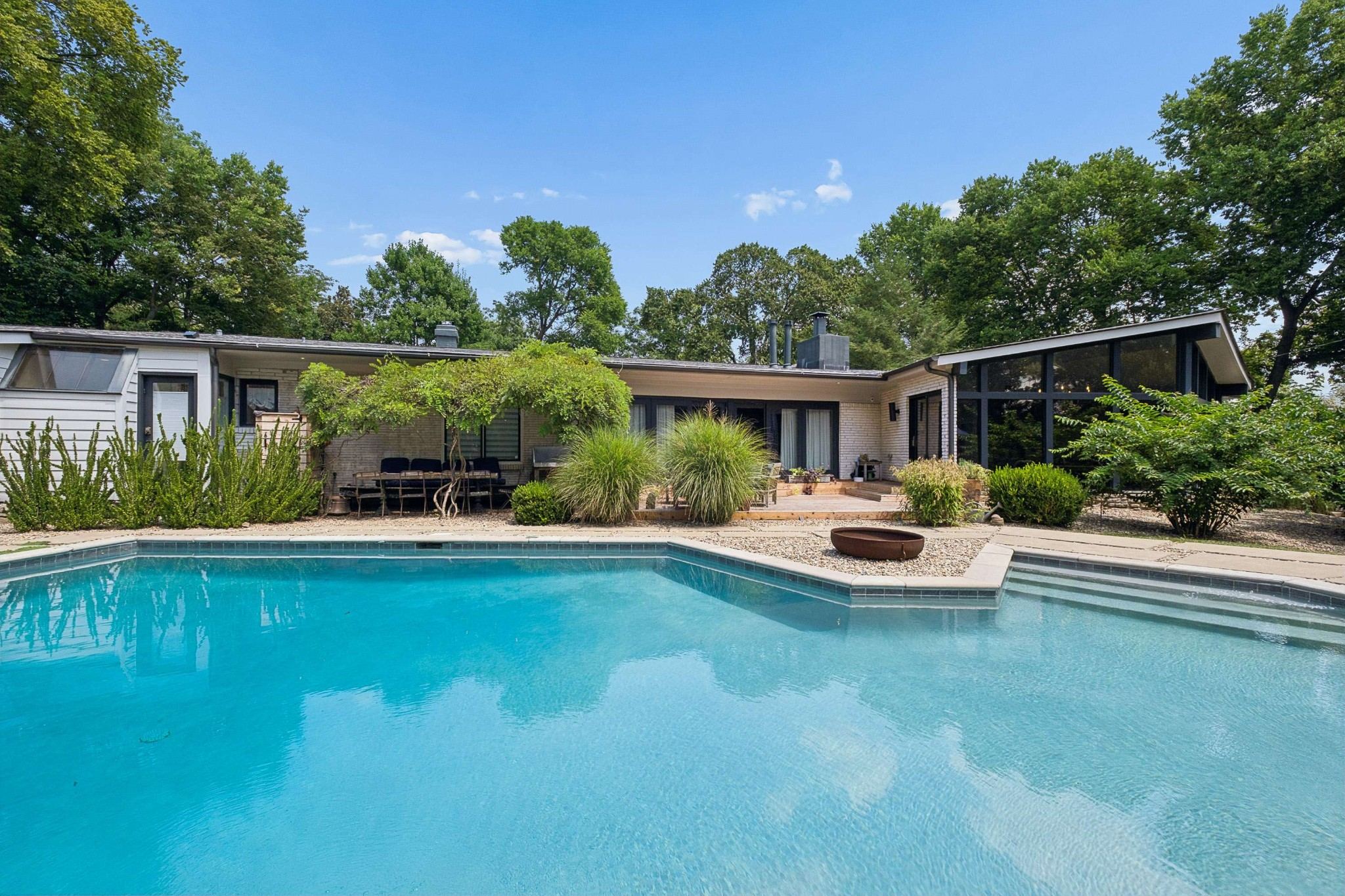 Gunite pool surrounded by stone decking and heavy landscaping behind 4301 Lillywood Road in Belle Meade Nashville