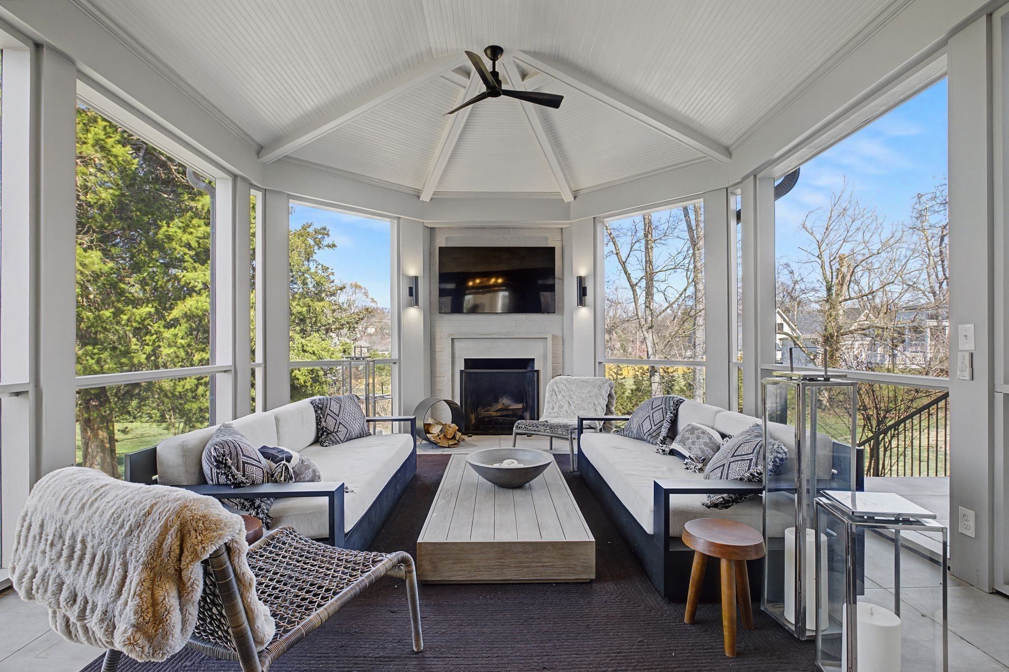 Screened porch with a wood burning fireplace and seating at 4304 Warner Place in Belle Meade Nashville