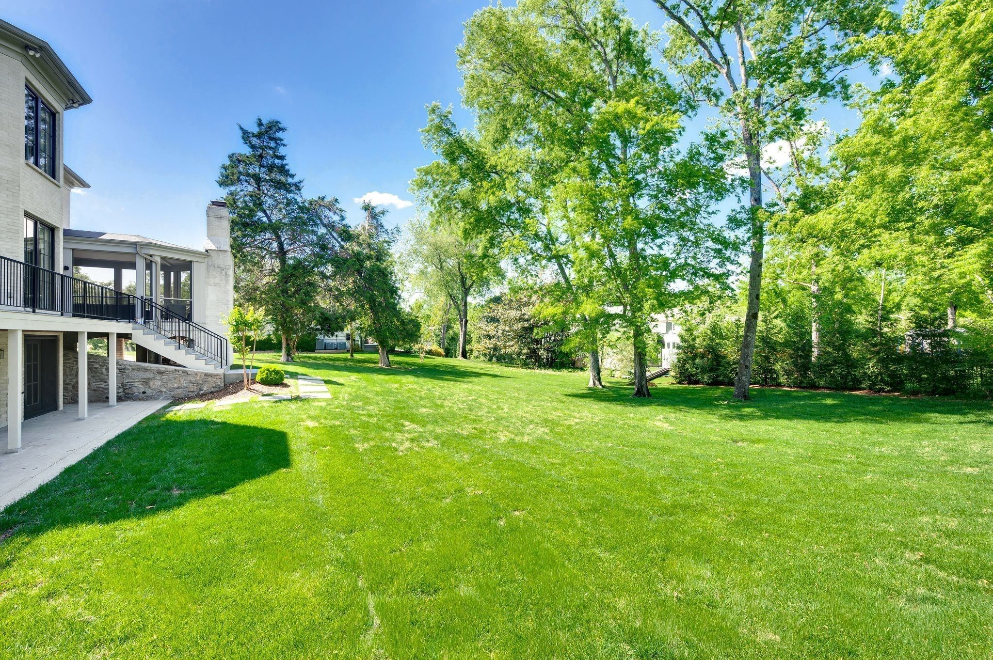 Expansive back lawn with trees behind 4304 Warner Place in Belle Meade Nashville