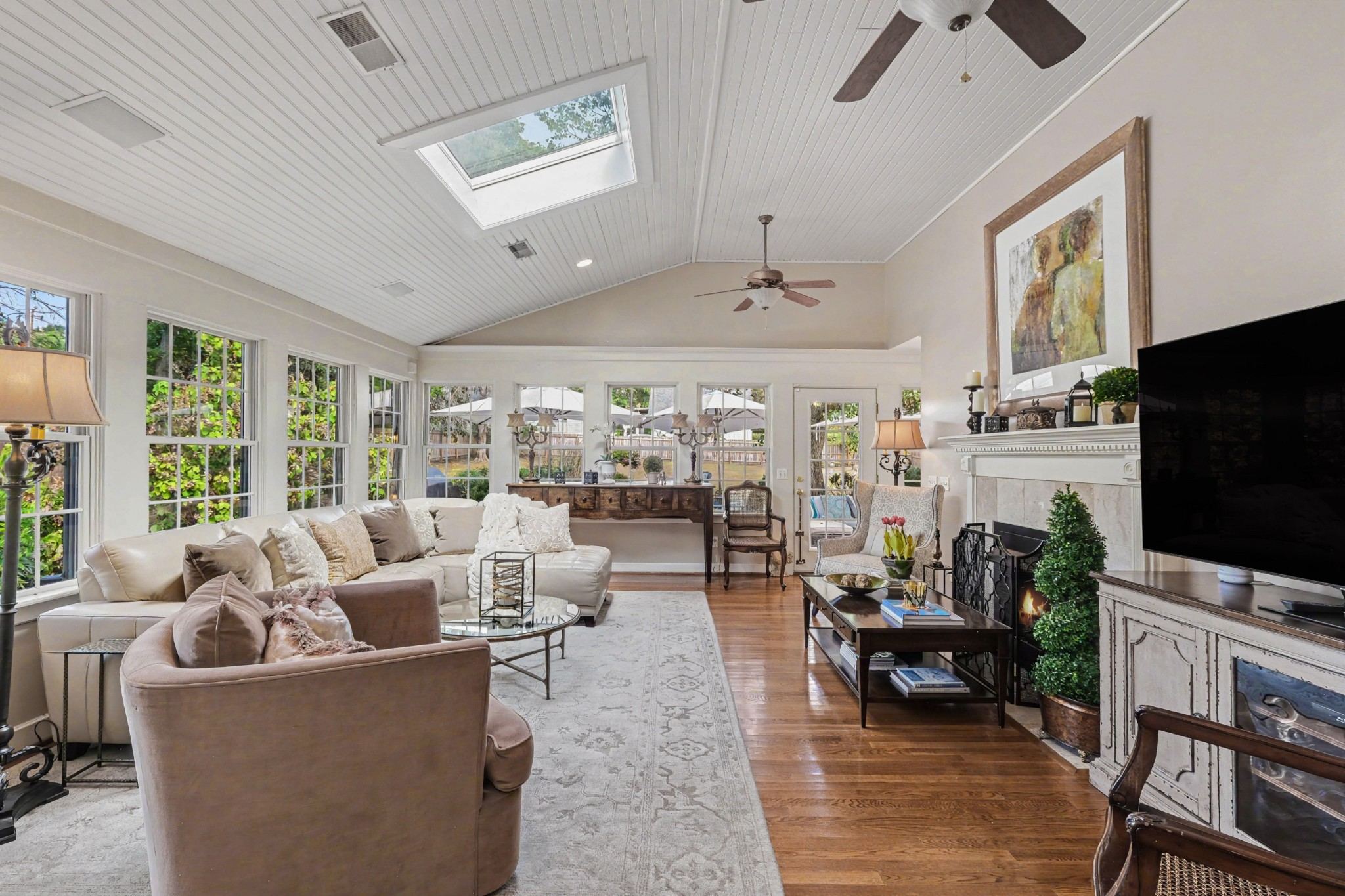 Vaulted living room with skylights, a ceiling fan and wood floors at 4306 Harding Place in Belle Meade Nashville