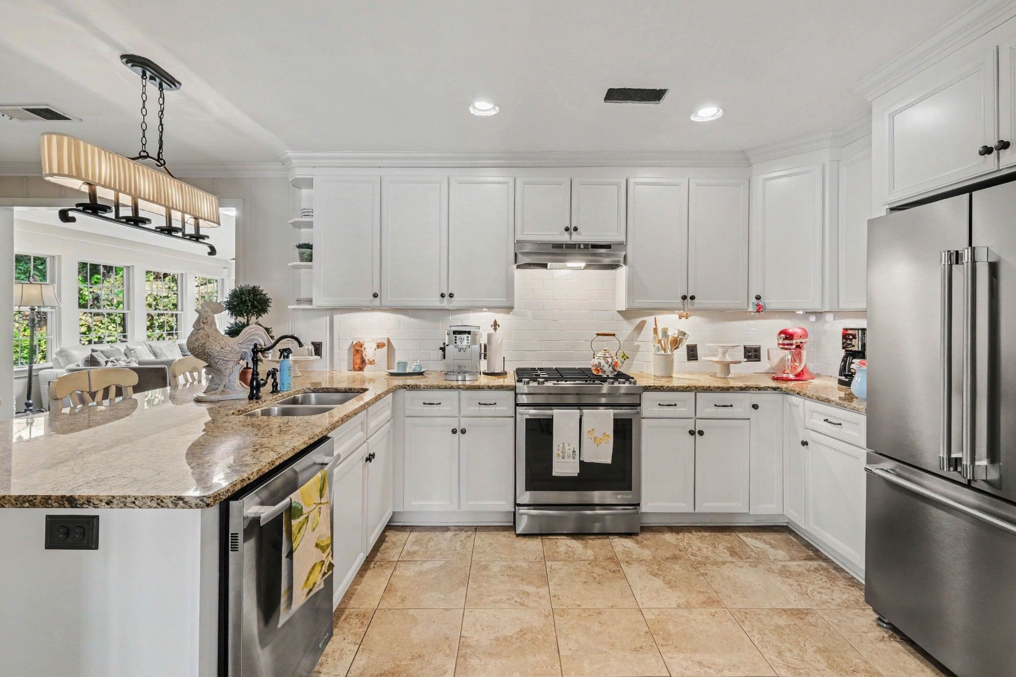 White kitchen with stainless appliances and stone counters at 4306 Harding Place in Belle Meade Nashville