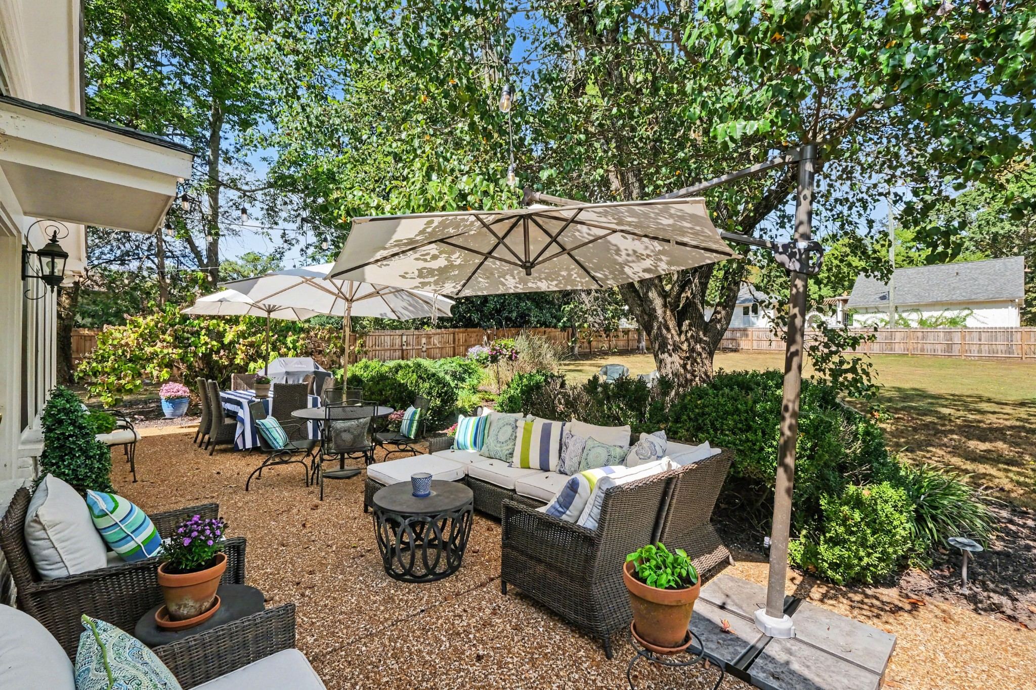 Fenced back patio with outdoor seating and a shade canopy at 4306 Harding Place in Belle Meade Nashville
