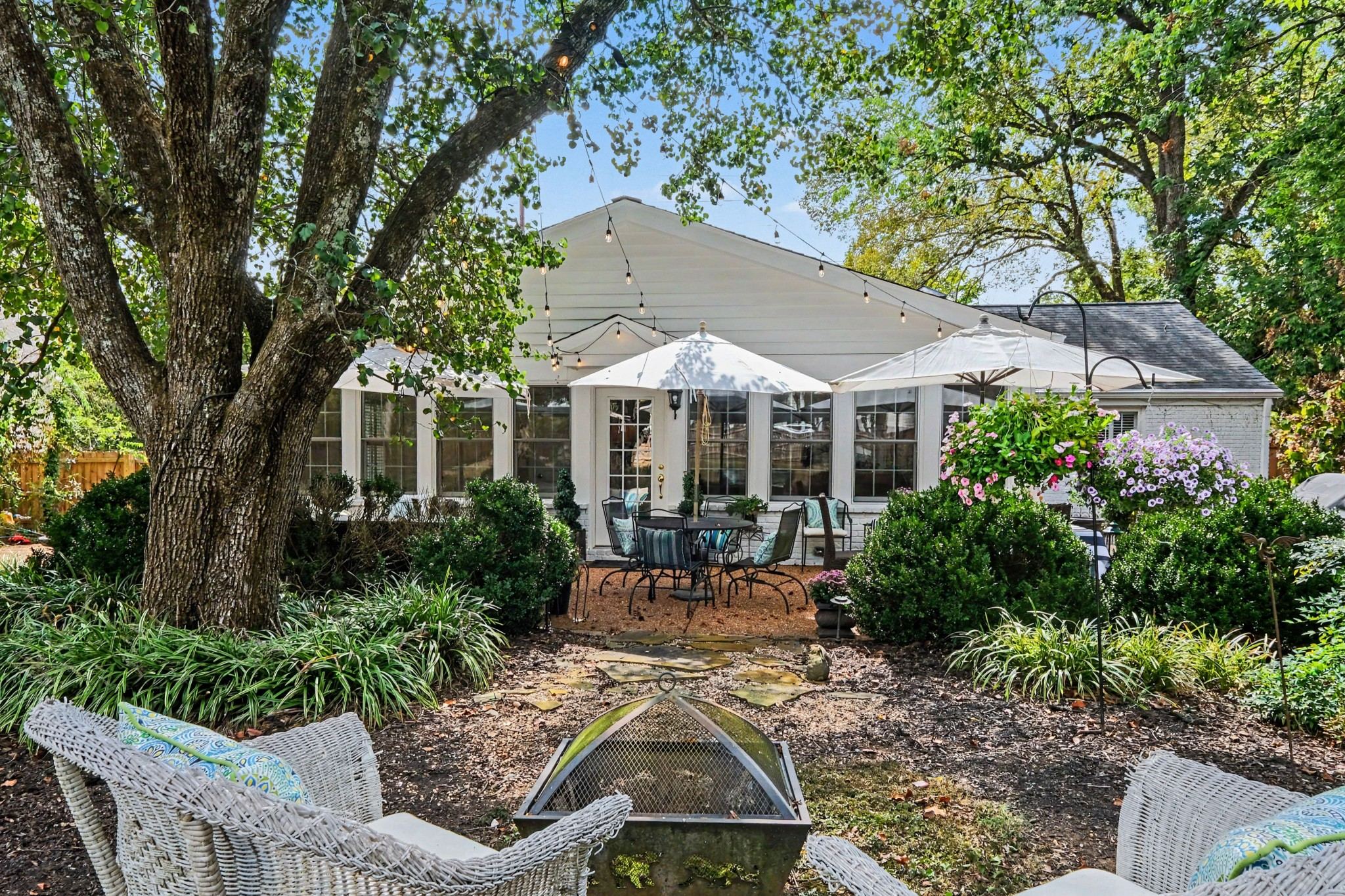 Rear exterior of 4306 Harding Place with a patio and garden beds in Belle Meade Nashville