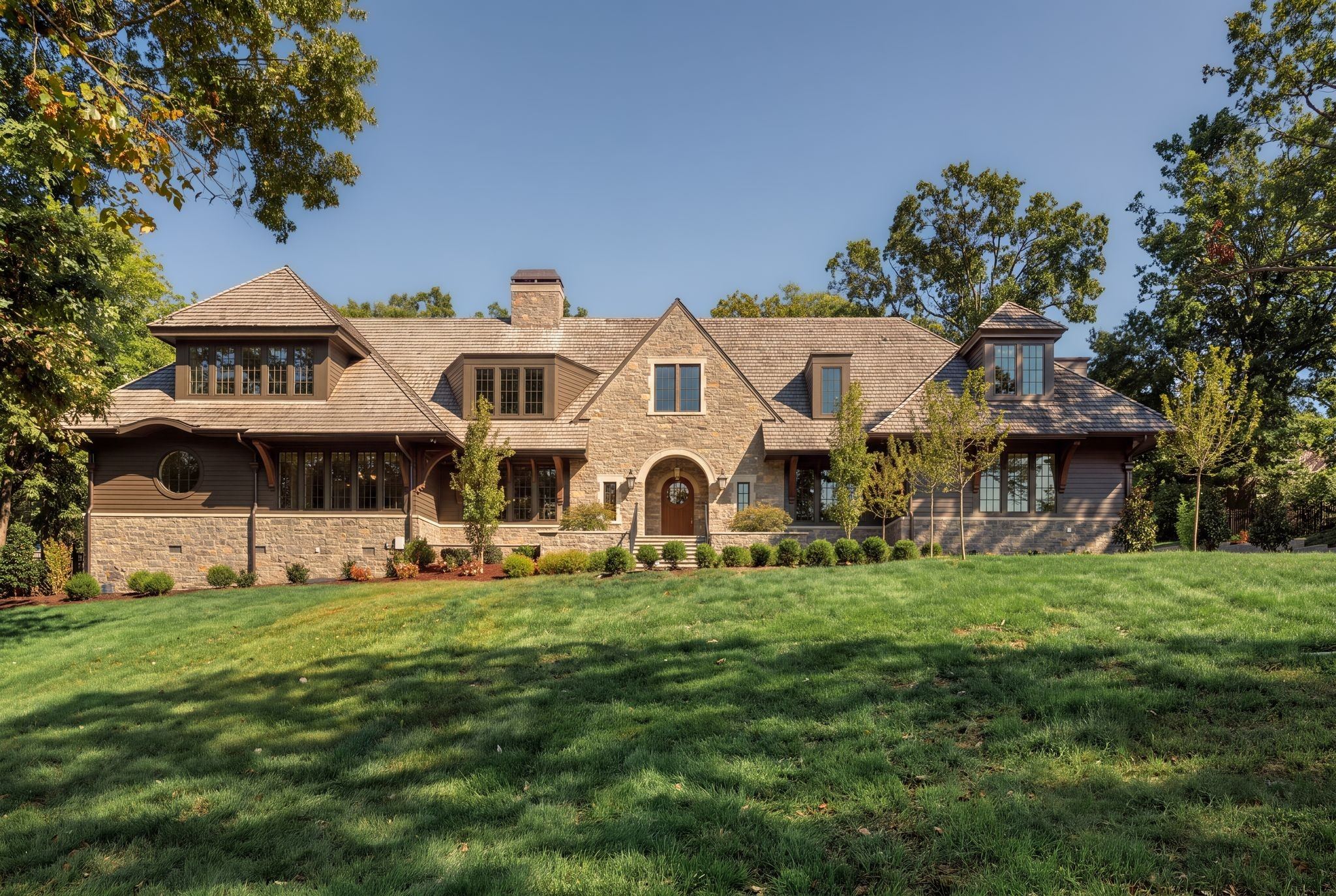 Front exterior of 606 Westview Avenue, a new stone and wood home with a steep roof and a wide front lawn