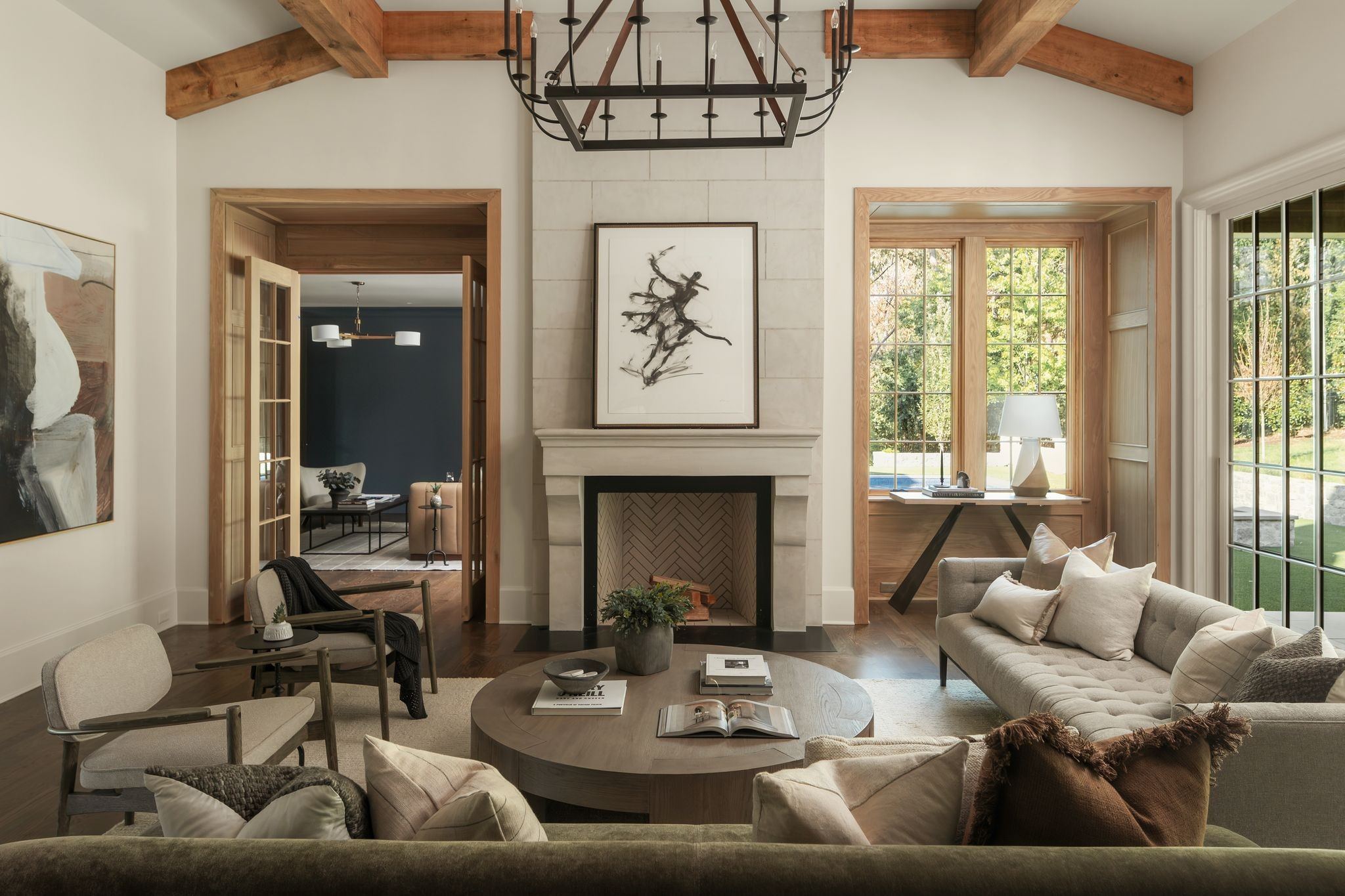 Vaulted living room with exposed wood beams, a fireplace and large windows at 606 Westview Avenue in Belle Meade Nashville
