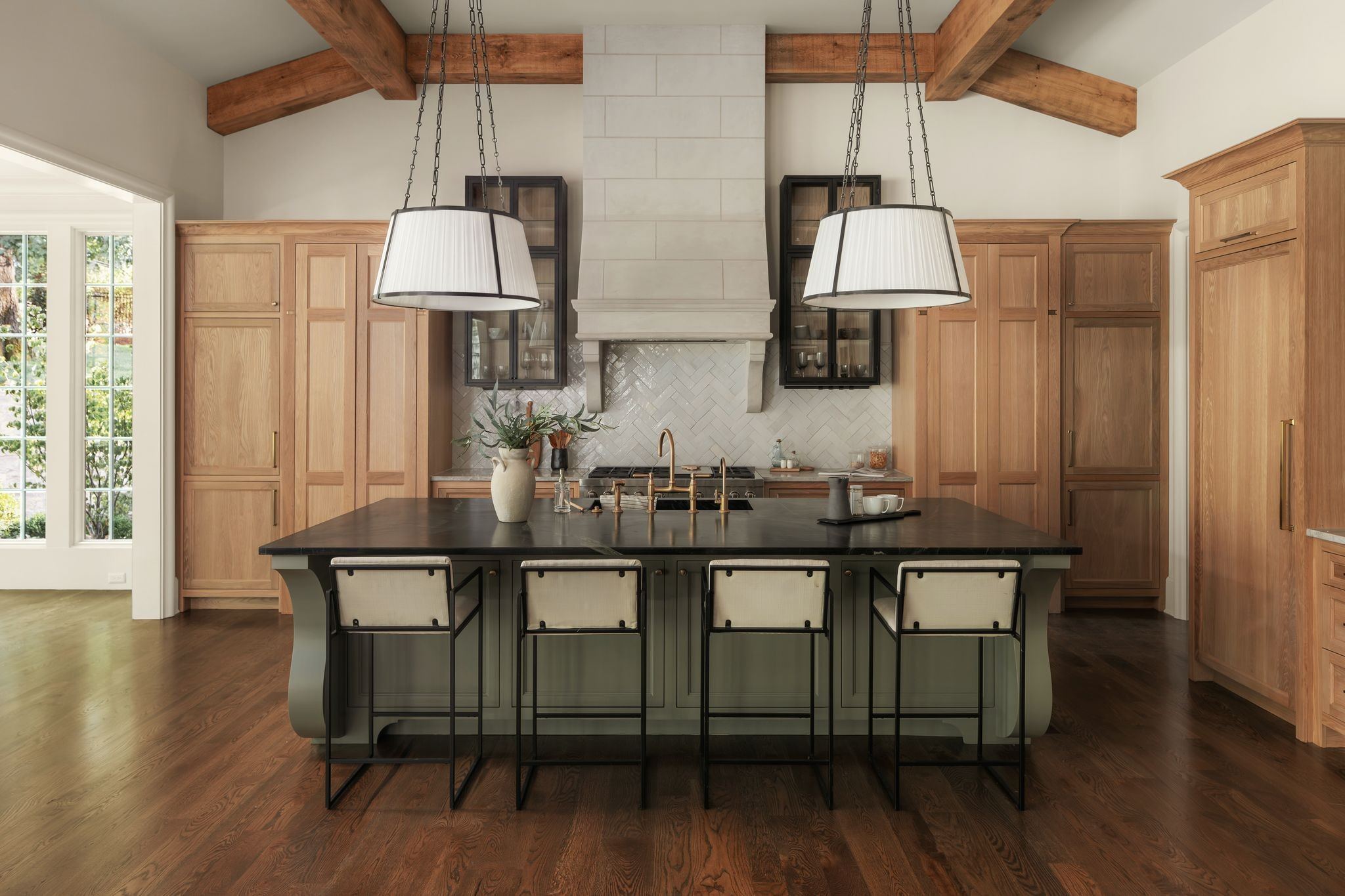 Kitchen with a large island, wood cabinetry, a range hood and pendant lights at 606 Westview Avenue in Belle Meade Nashville